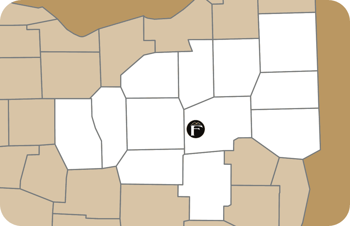 A stylized map with several regions shaded brown and others white; a black "F" icon, representing Shane Fisk Roofing, is placed in one of the central white regions.
